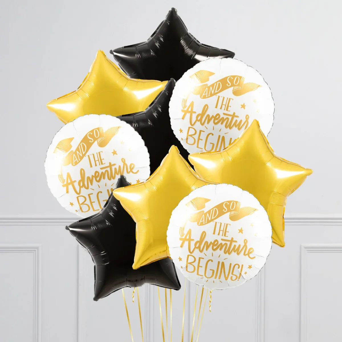 Black, gold star-shaped and white round graduation balloons with 'And So The Adventure Begins' text