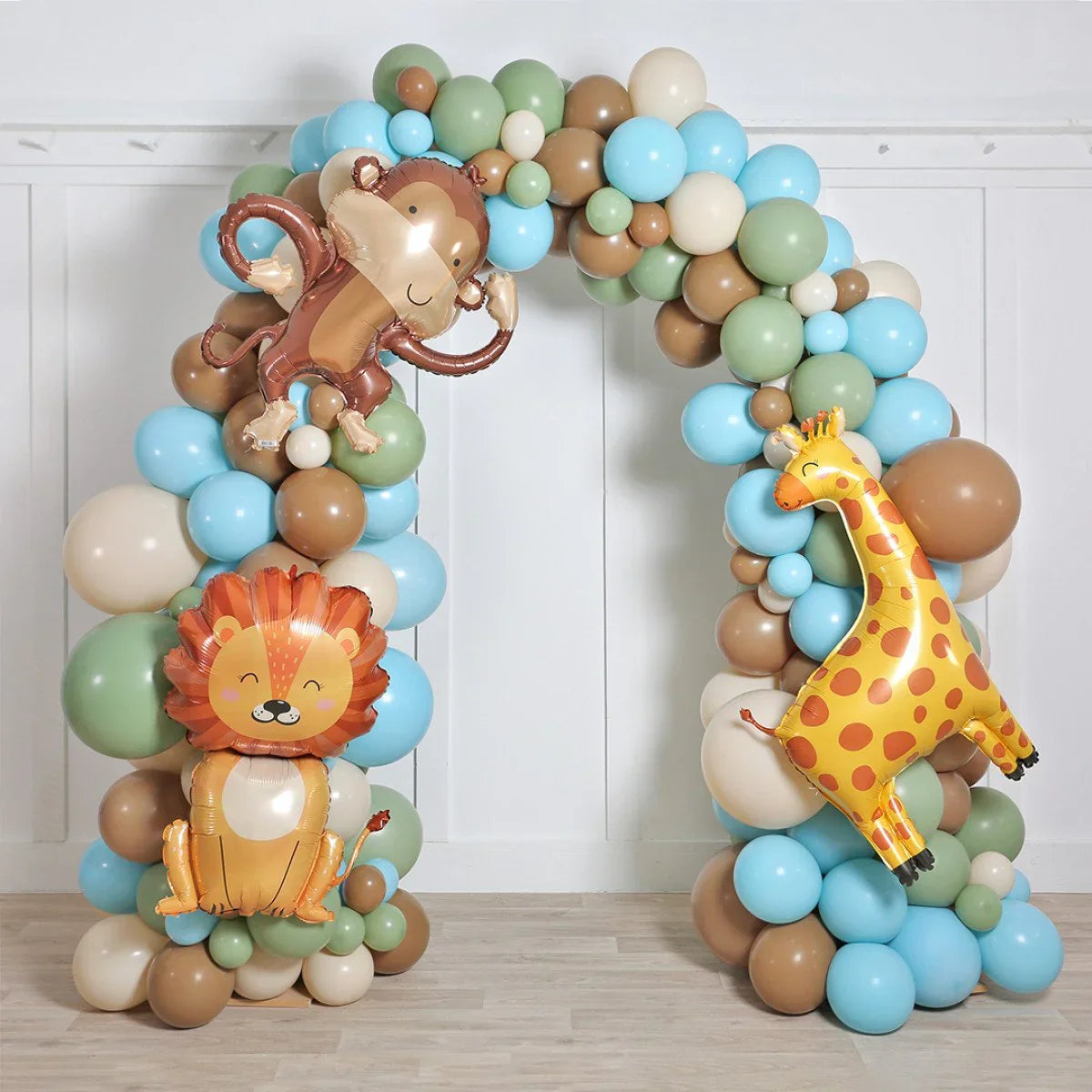 Safari-themed balloon arch with monkey, lion, and giraffe animal balloons in pastel blue, green, and brown