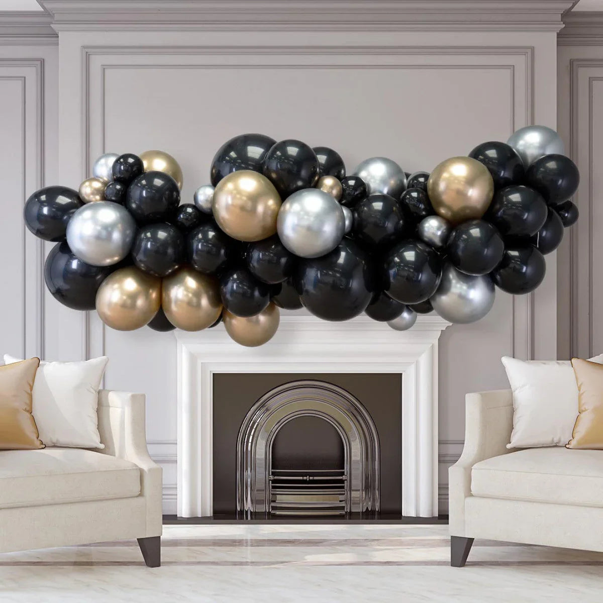 Black, gold, and silver balloon garland decorating a modern fireplace in a neutral living room