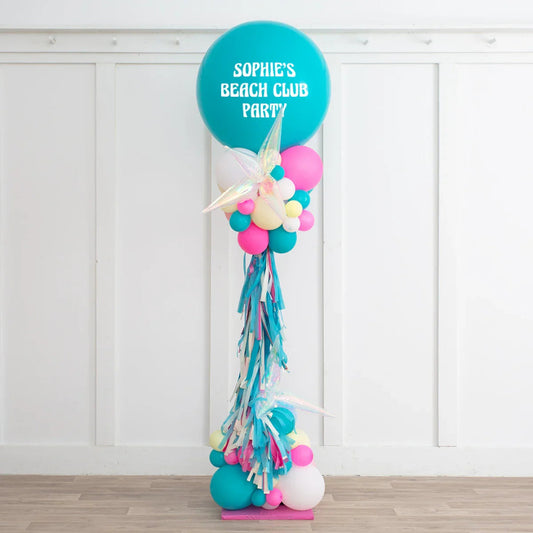 Tall balloon pillar decoration with teal, pink, white balloons and iridescent star shapes for Sophie's Beach Club Party