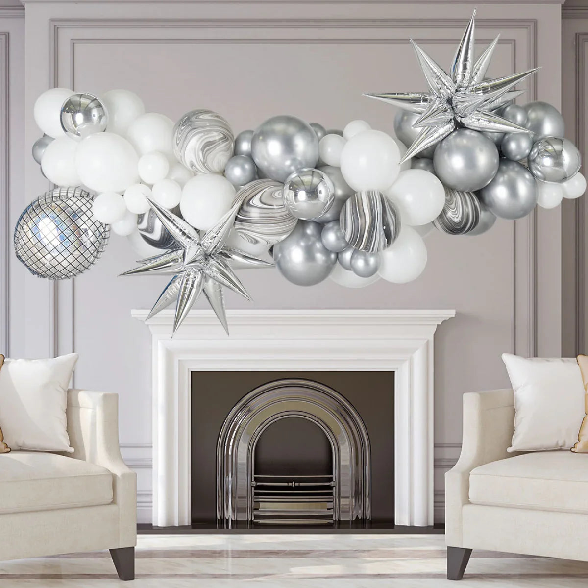 Silver and white balloon garland with star and disco ball foils over a white fireplace in elegant living room