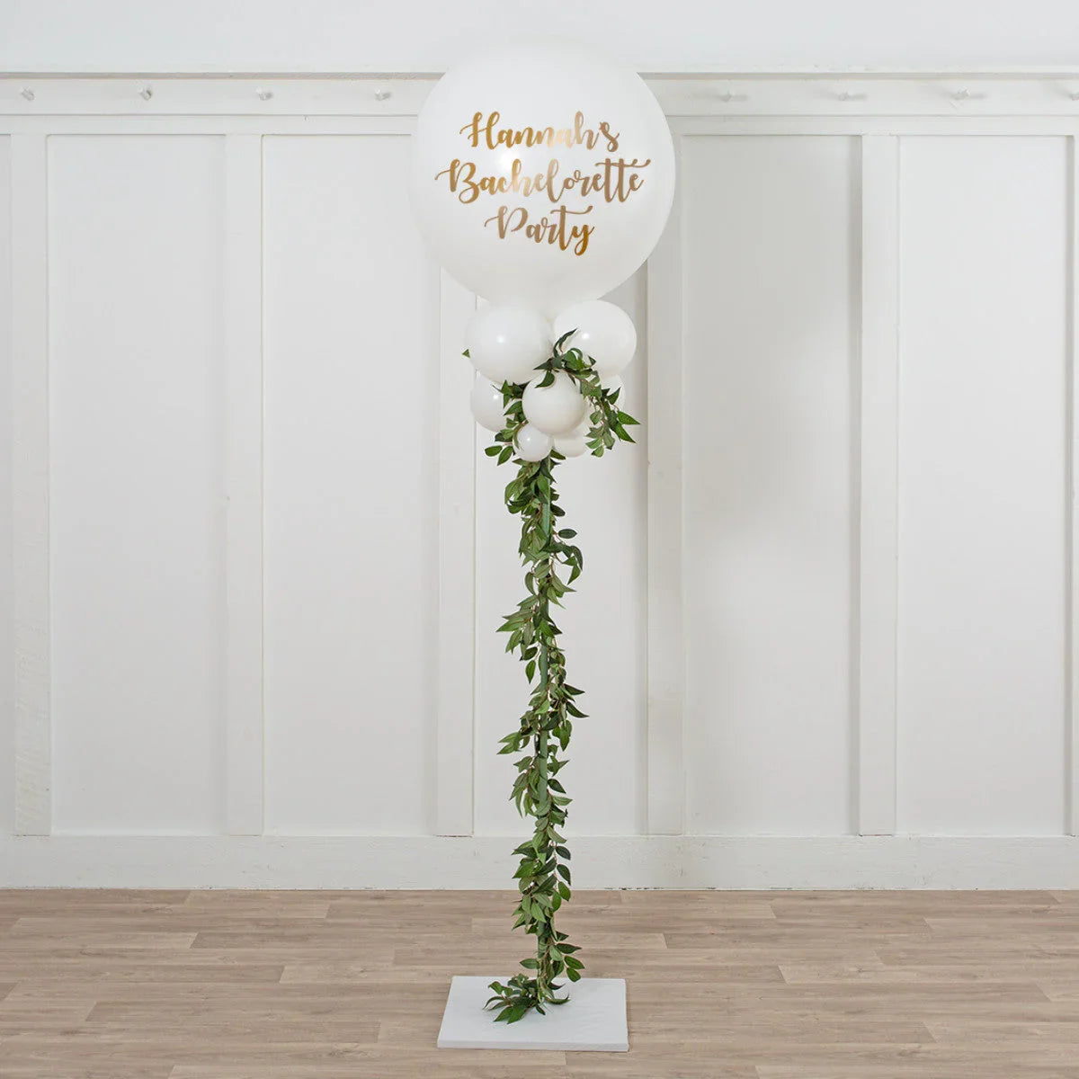 White balloon garland with green leaves for Hannah's bachelorette party decoration