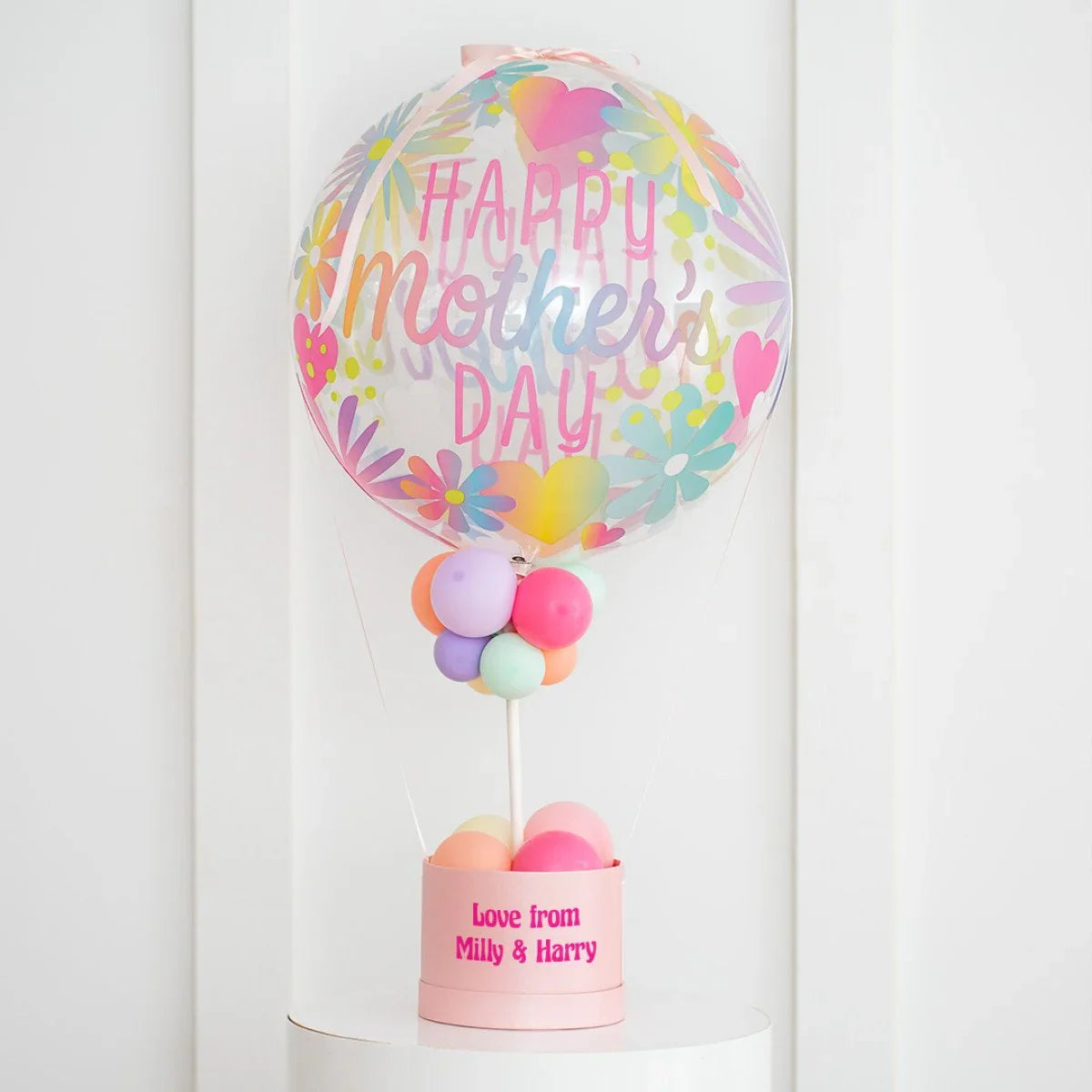 Colorful Mother's Day balloon with floral design and personalized gift box reading Love from Milly & Harry