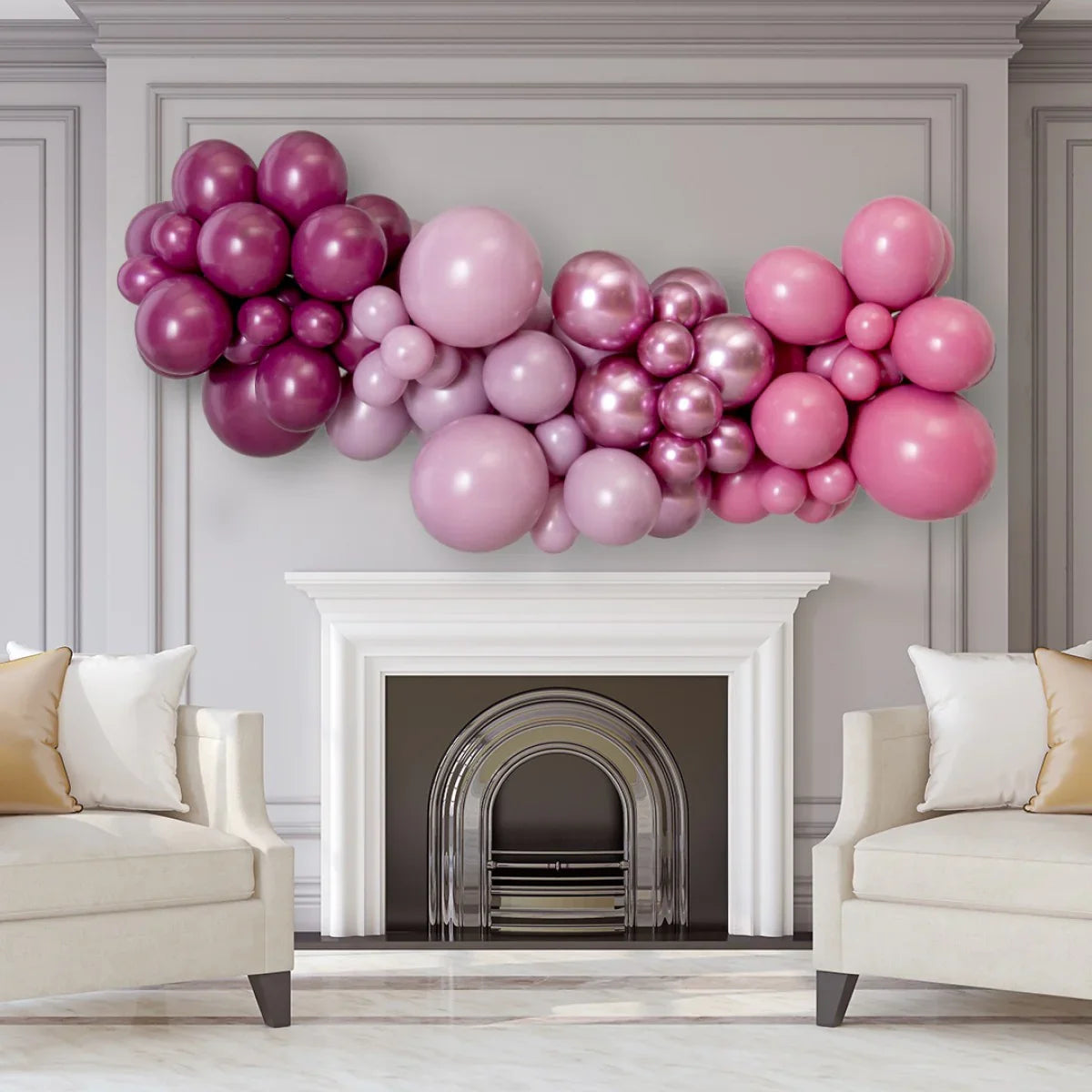 Mulberry and pink inflated balloon garland above white fireplace in elegant living room