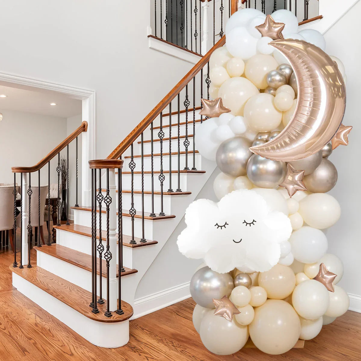 Neutral balloon pillar decoration with white cloud, rose gold crescent moon and stars near staircase