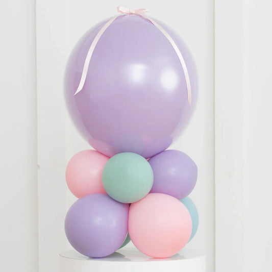 Pastel purple, pink, and teal balloon stack with large lavender air-filled bubble balloon on top