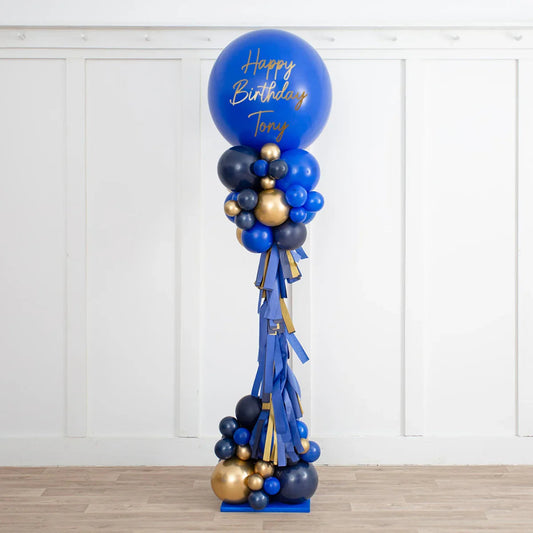 Personalised sapphire blue and gold balloon pillar with Happy Birthday Tony message