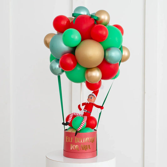 Personalised Elf on the Shelf in red, green, and gold balloon hot air balloon with Elf Delivery for Aria