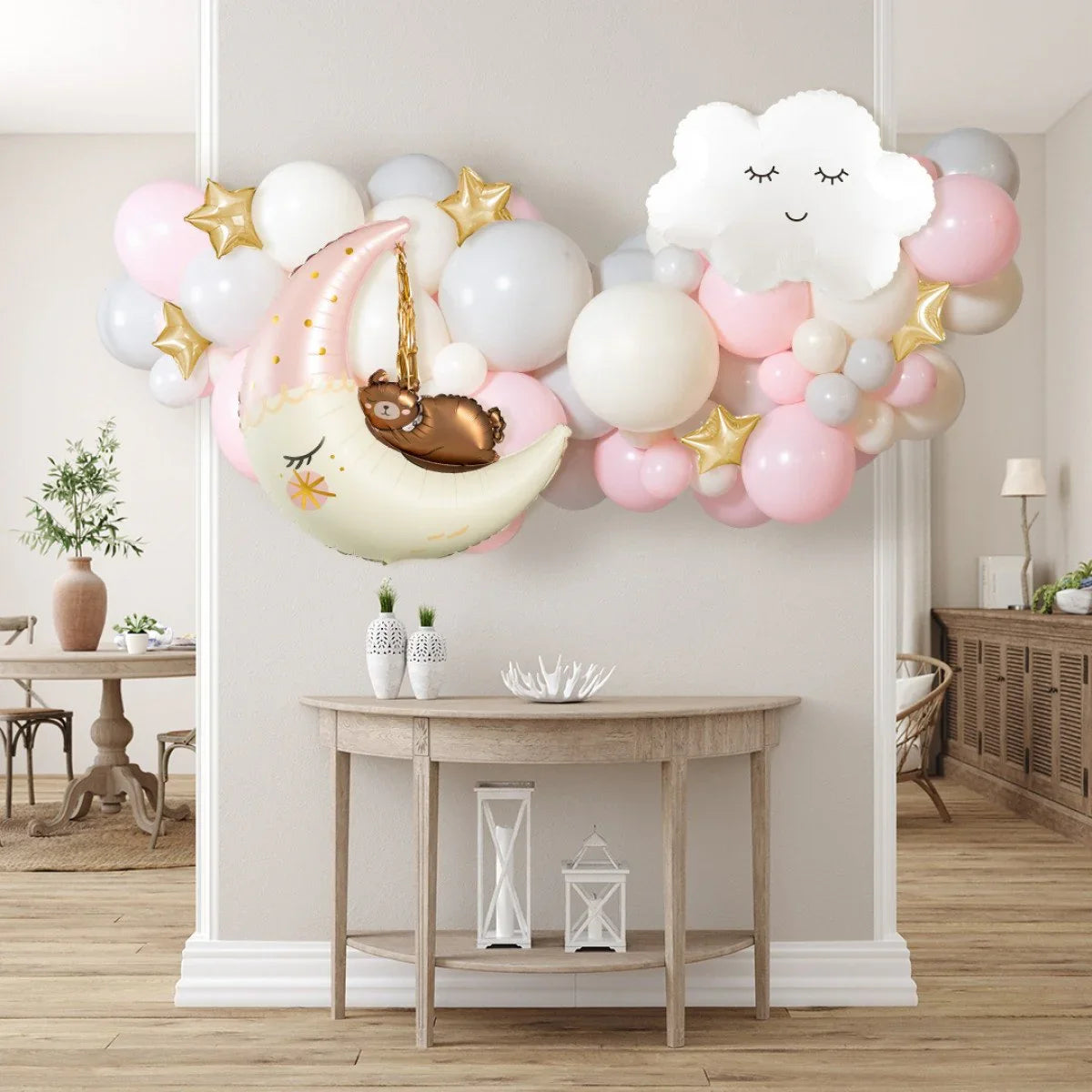 Baby shower balloon garland with moon, cloud, and bear foil balloons in pink, white, gray, and gold stars