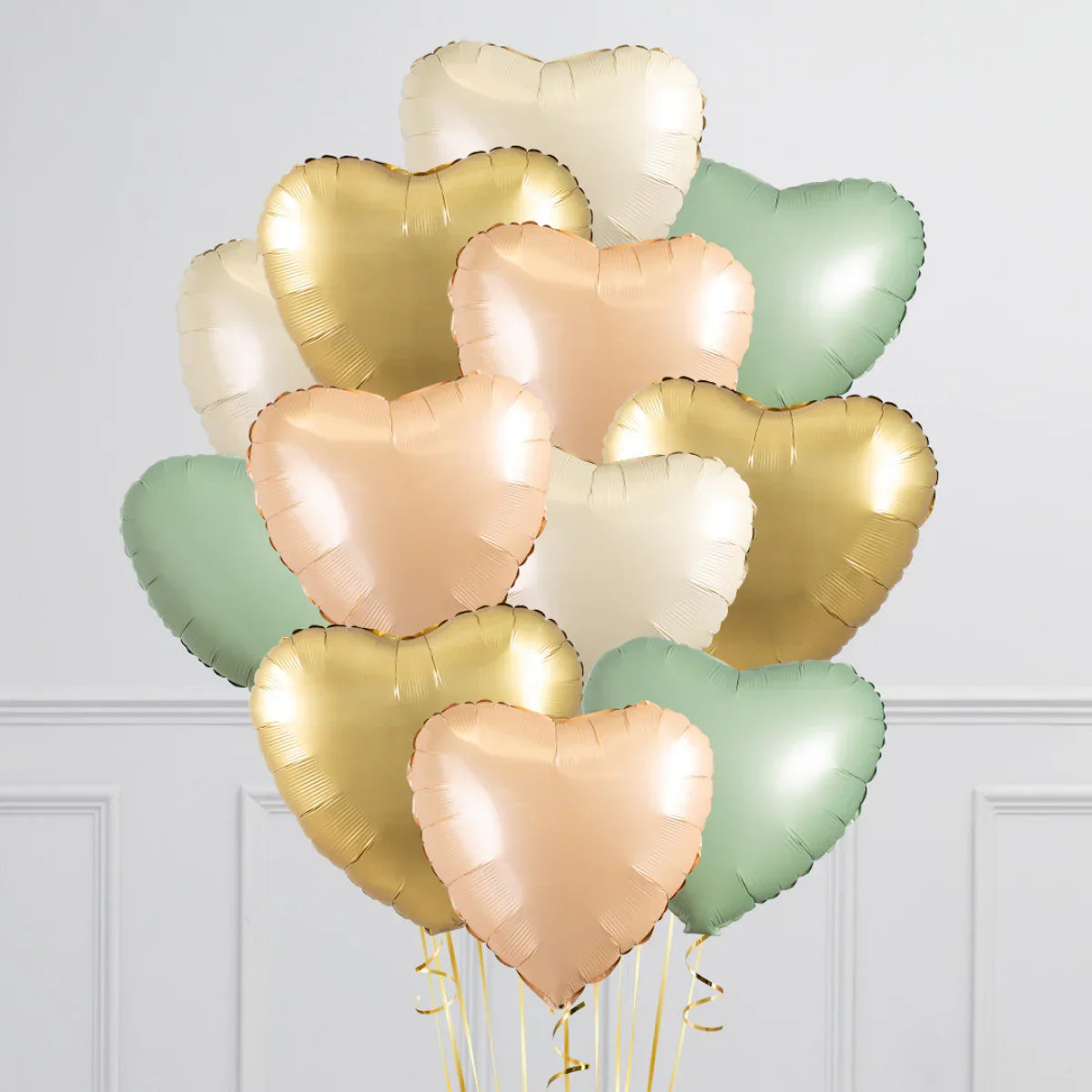 Bunch of heart-shaped foil balloons in sage green, blush pink, cream, and gold colors