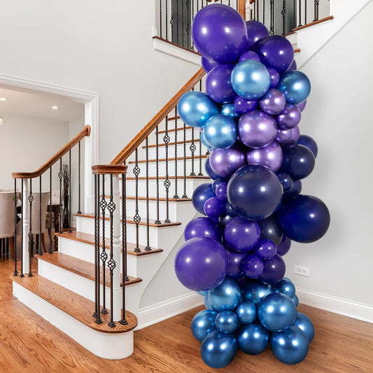 Inflated balloon pillar with purple and blue metallic balloons decorating wooden staircase in modern home