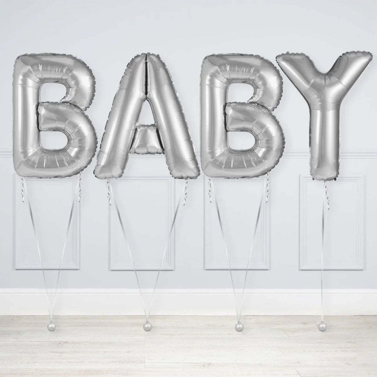 Silver foil letter balloons spelling BABY, decorated for baby shower or celebration