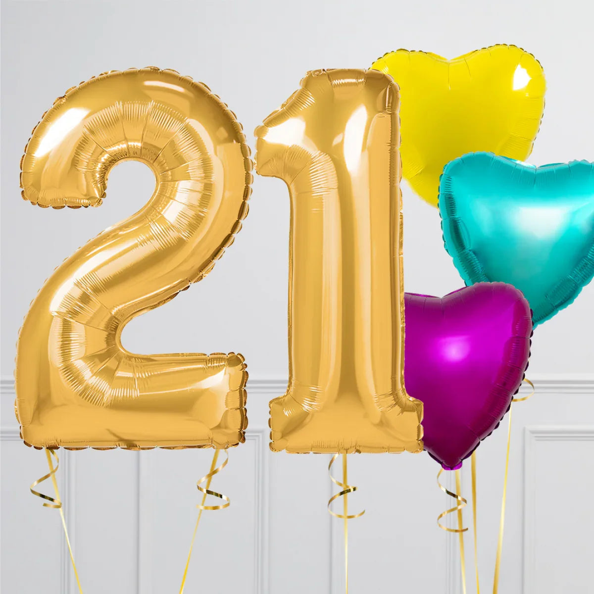 Gold number 21 balloons with purple, teal, and yellow heart-shaped balloons on white background