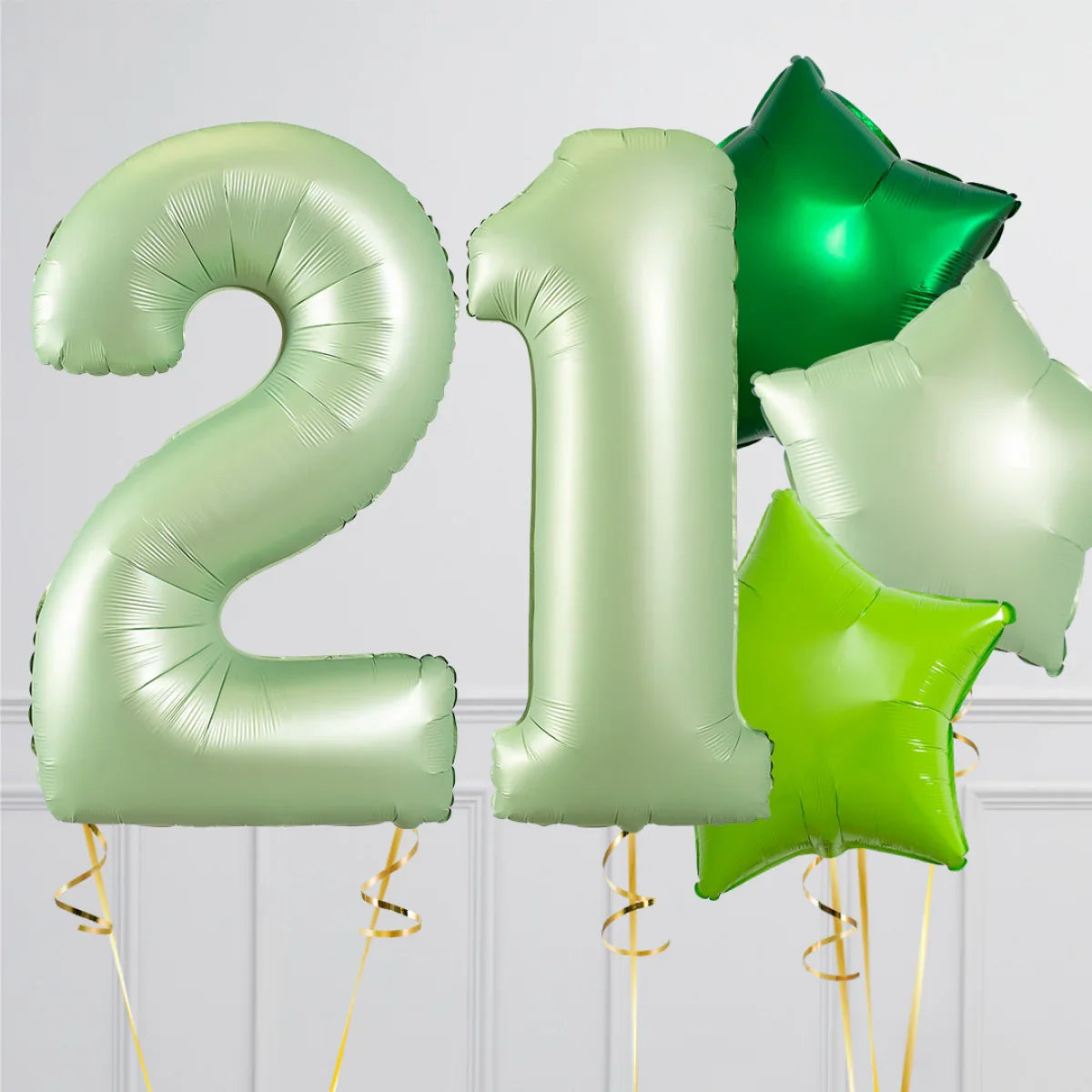 Metallic light green number 21 balloons with green star-shaped balloons on white background