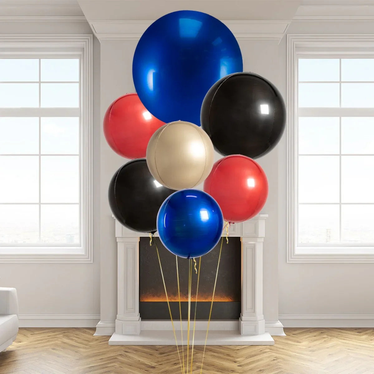 Cluster of shiny blue, red, black, and gold giant round balloons in a bright room with fireplace and windows