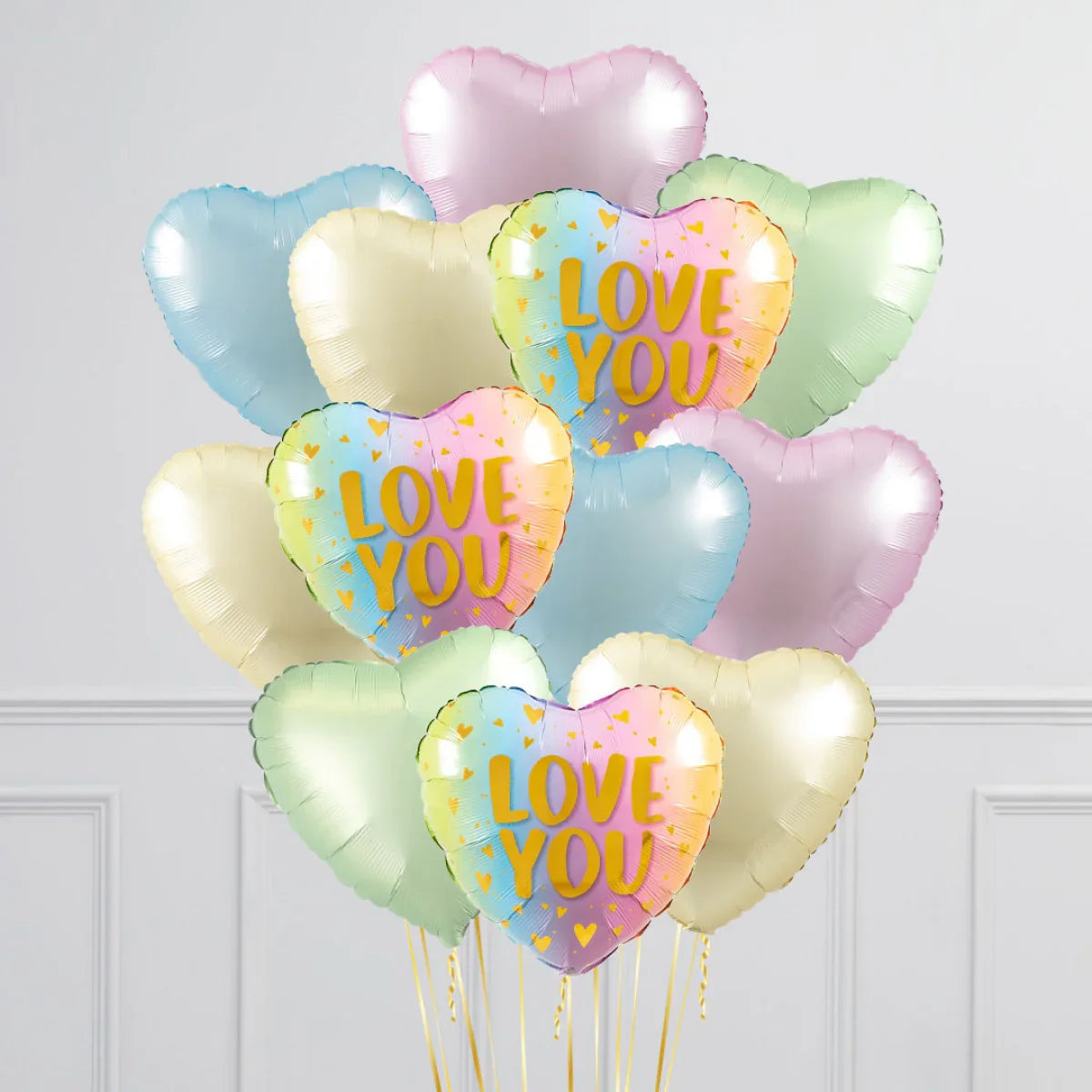 Colorful heart-shaped balloons with three pastel rainbow "LOVE YOU" balloons and other pastel blue, green, purple, and cream balloons