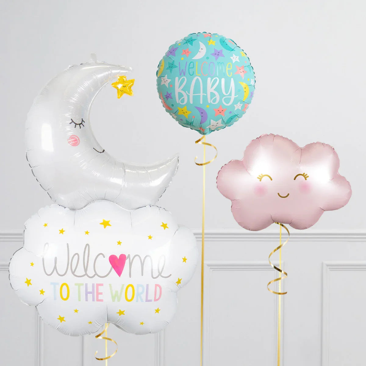 Baby shower balloons including sleeping moon with star, welcome to the world cloud, and pink smiling cloud
