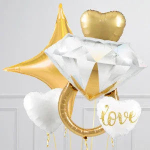 Gold and white heart-shaped and star balloons with a large diamond ring balloon and love inscription.