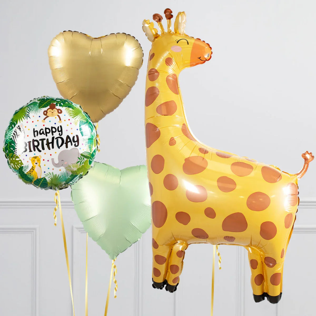 Safari themed birthday balloons including a large giraffe, gold and green hearts, and animal print happy birthday