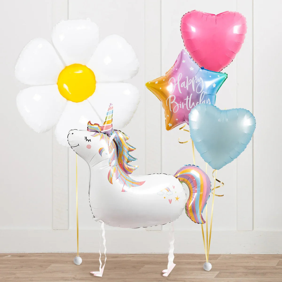 Colorful unicorn-shaped balloon with rainbow mane and tail, surrounded by flower, heart, star Happy Birthday balloons