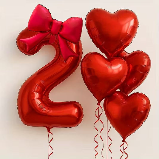 Red foil balloon number 2 with a large red bow and four red heart-shaped foil balloons with ribbons