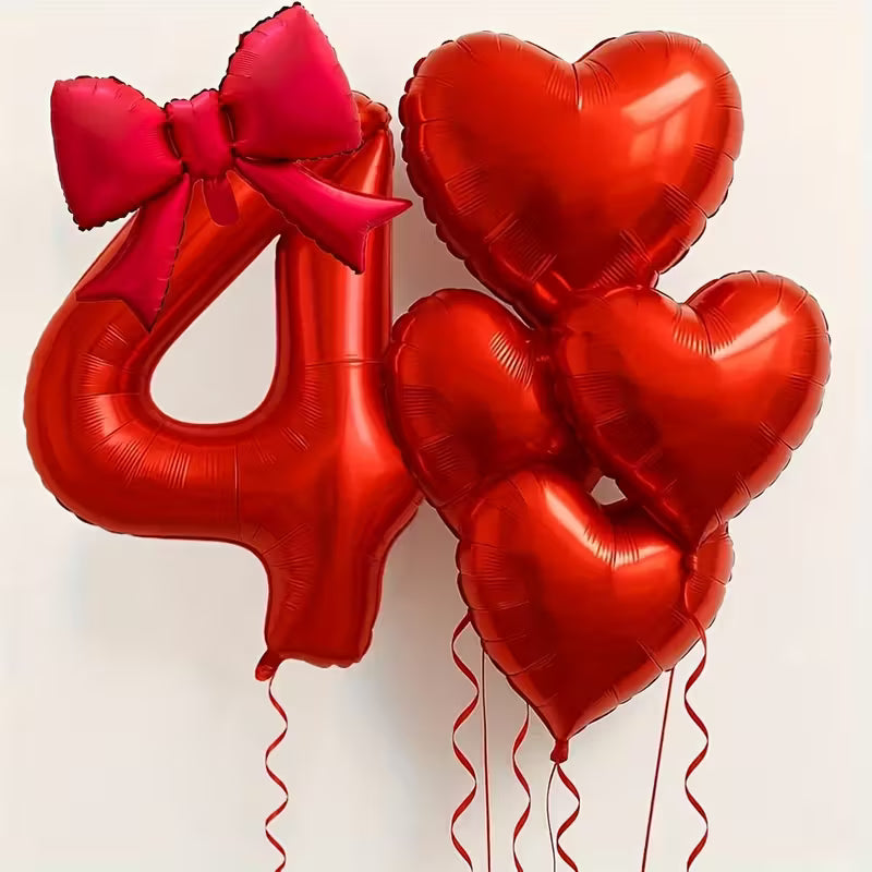 Red foil balloons set with number 4 balloon topped by red bow and four heart-shaped balloons