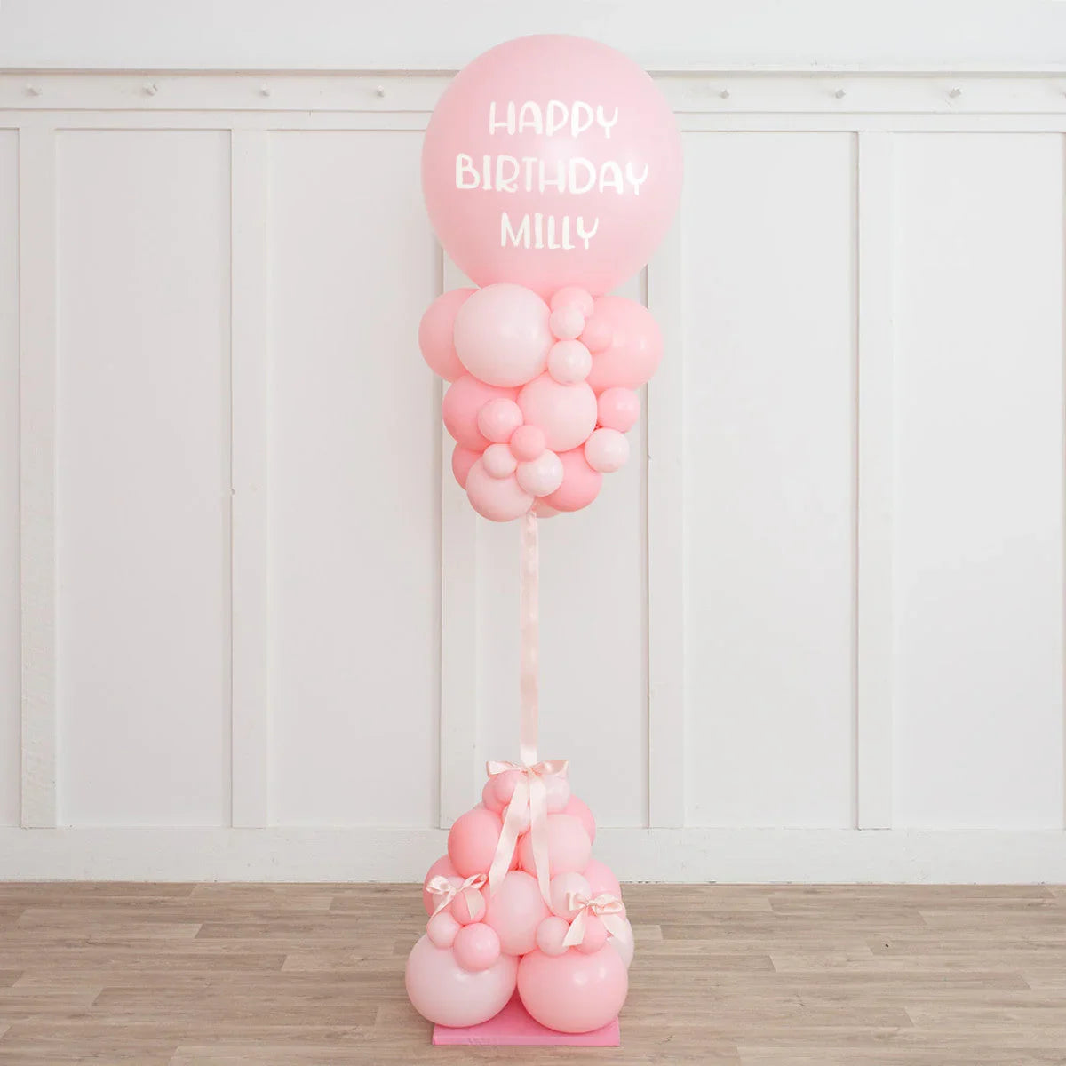 Elegant baby pink balloon pillar with Happy Birthday Milly text, perfect birthday party decor