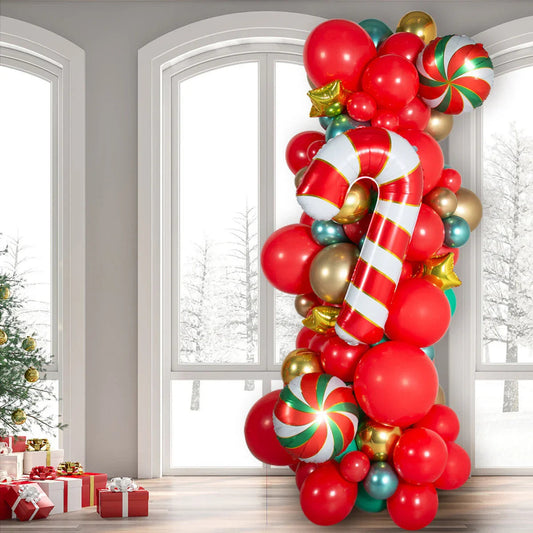 Christmas balloon pillar with red, gold, green balloons, candy cane and peppermint decorations in a bright room