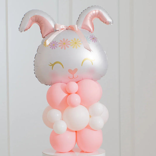 Pink and white balloon bunny with floral crown and bow, Easter-themed party decoration