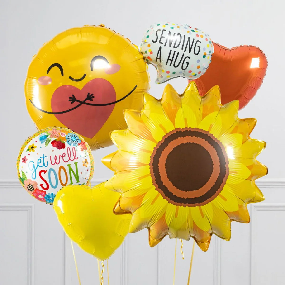 Colorful get well soon balloons including sunflower, heart, emoji hug, and sending a hug message