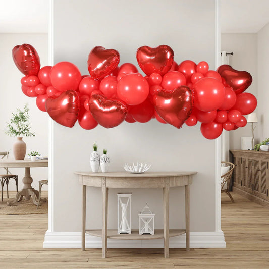 Red heart-shaped and round balloon garland decoration in bright modern living room