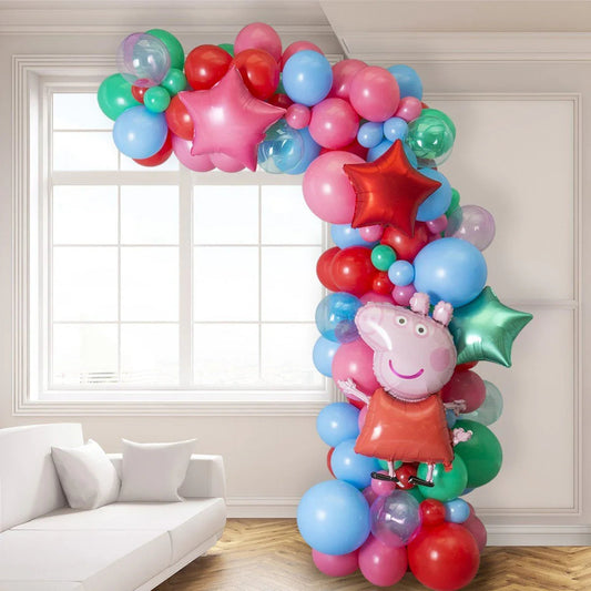 Colorful asymmetric balloon arch with Peppa Pig foil balloon and star-shaped balloons in a bright room