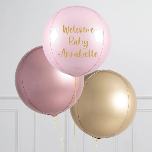 Personalized pink balloon with gold text Welcome Baby Annabelle, alongside rose gold and gold balloons