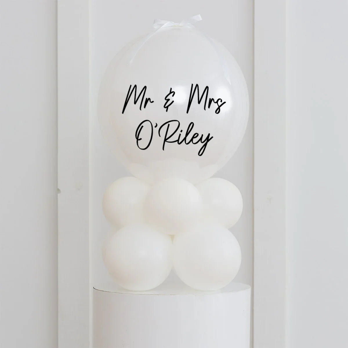 White personalised Mr & Mrs O'Riley bubble balloon decoration on white balloon base
