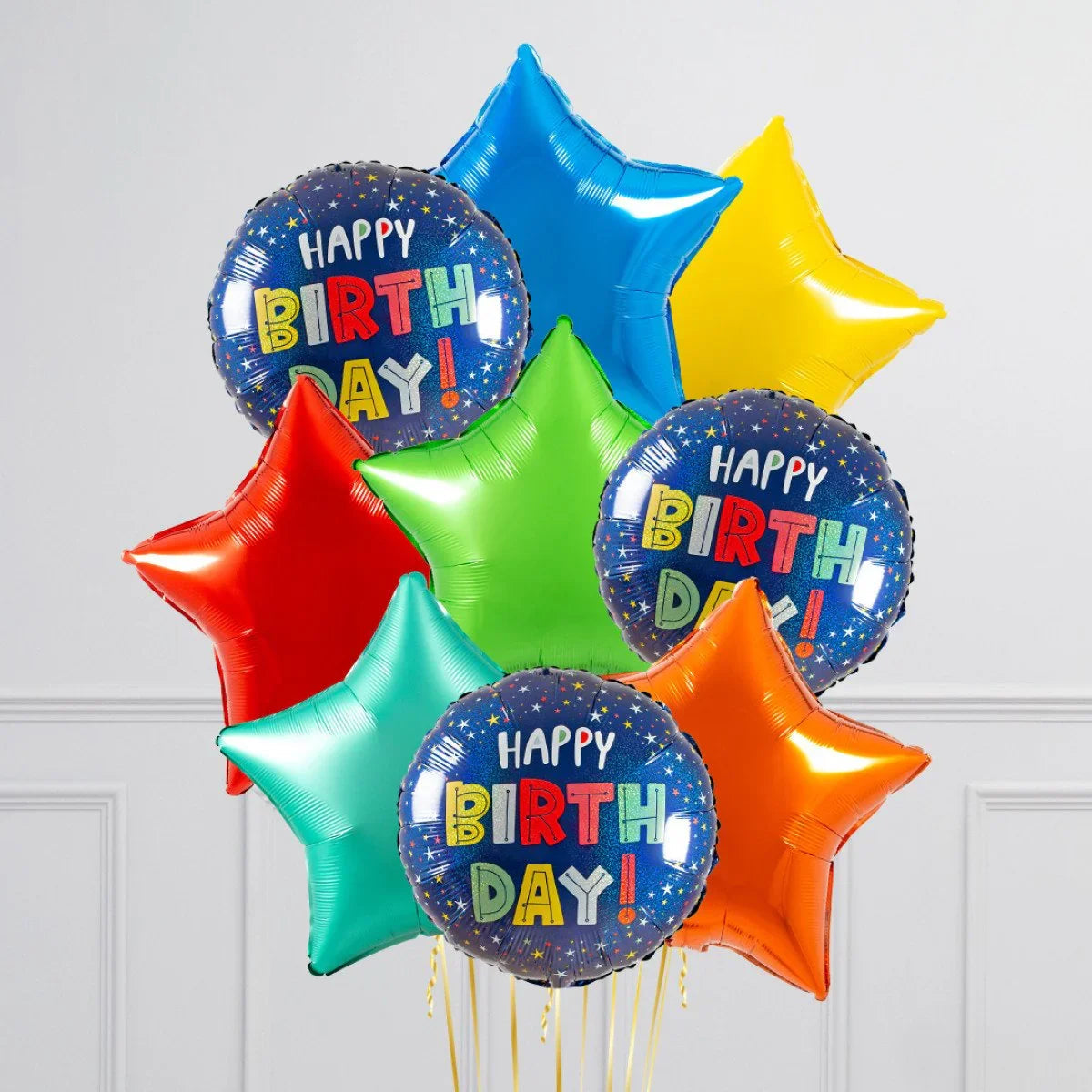 Colorful foil balloons bouquet with star shapes and 'Happy Birthday' round balloons on white background