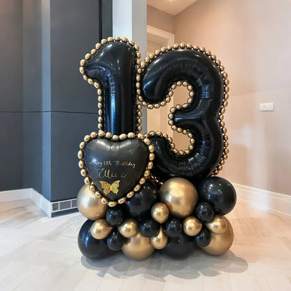 Black and gold balloon arrangement with number 13 and heart-shaped balloon for 13th birthday celebration