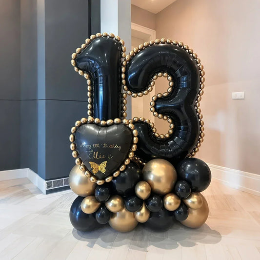 Black and gold balloon arrangement with number 13 and heart-shaped balloon for 13th birthday celebration
