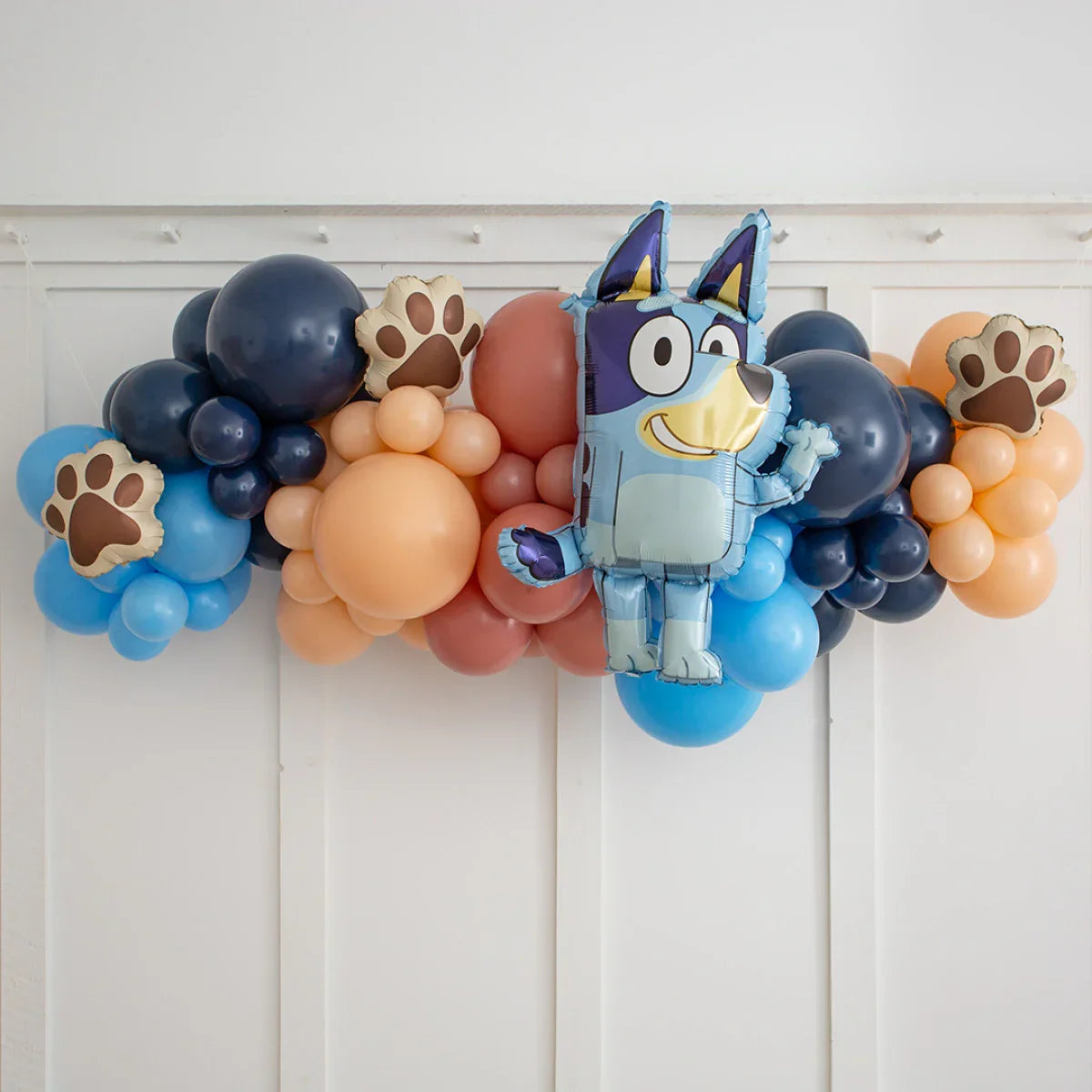 Bluey character balloon with blue, peach, and navy balloons and paw print foil balloons garland