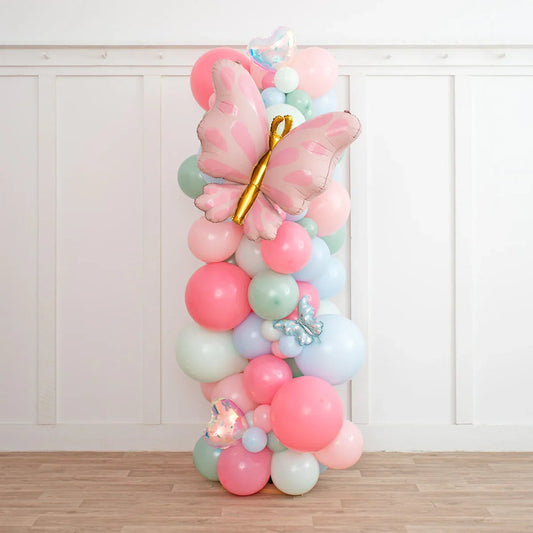 Colorful balloon pillar decoration with large pink butterfly balloon and pastel round balloons