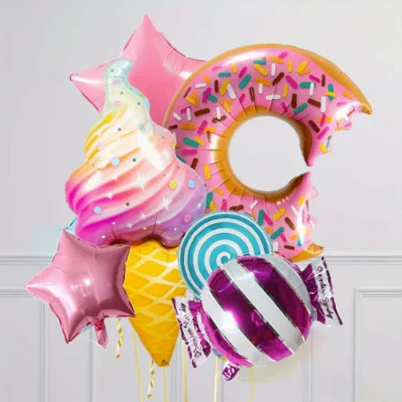 Colorful candy-themed balloons including ice cream cone, pink donut, lollipop, wrapped candy, and pink star shapes