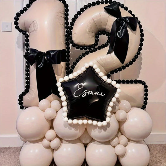 Caramel-colored number 12 balloon stack decorated with black bows and white balloons for celebration