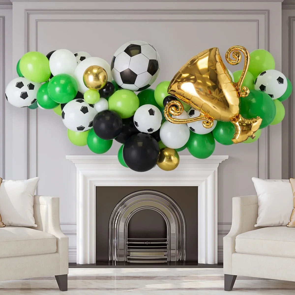 Football-themed balloon garland with soccer ball prints and gold trophy balloon over white fireplace