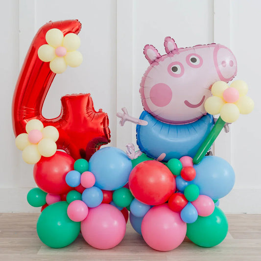 Colorful balloon arrangement with red number 4 and cartoon pig figure on wooden floor
