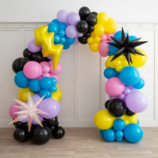 Colorful balloon arch with yellow, pink, blue, black, purple balloons and star-shaped foil balloons