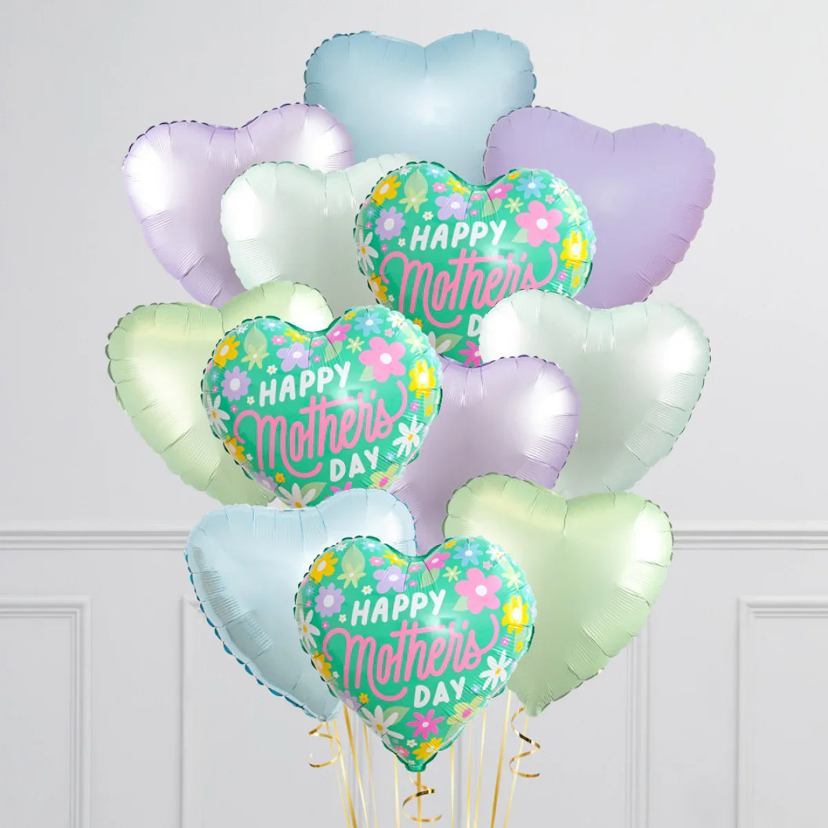 Heart-shaped foil balloon bunch with Happy Mother's Day text and floral design in pastel colors