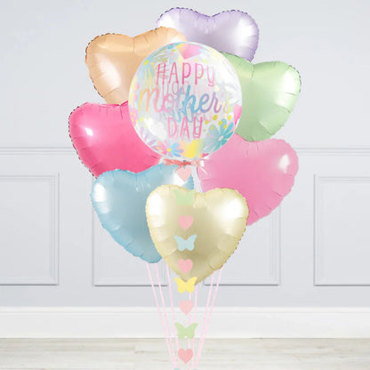 Happy Mother's Day pastel heart-shaped foil balloons with colorful floral balloon in white room