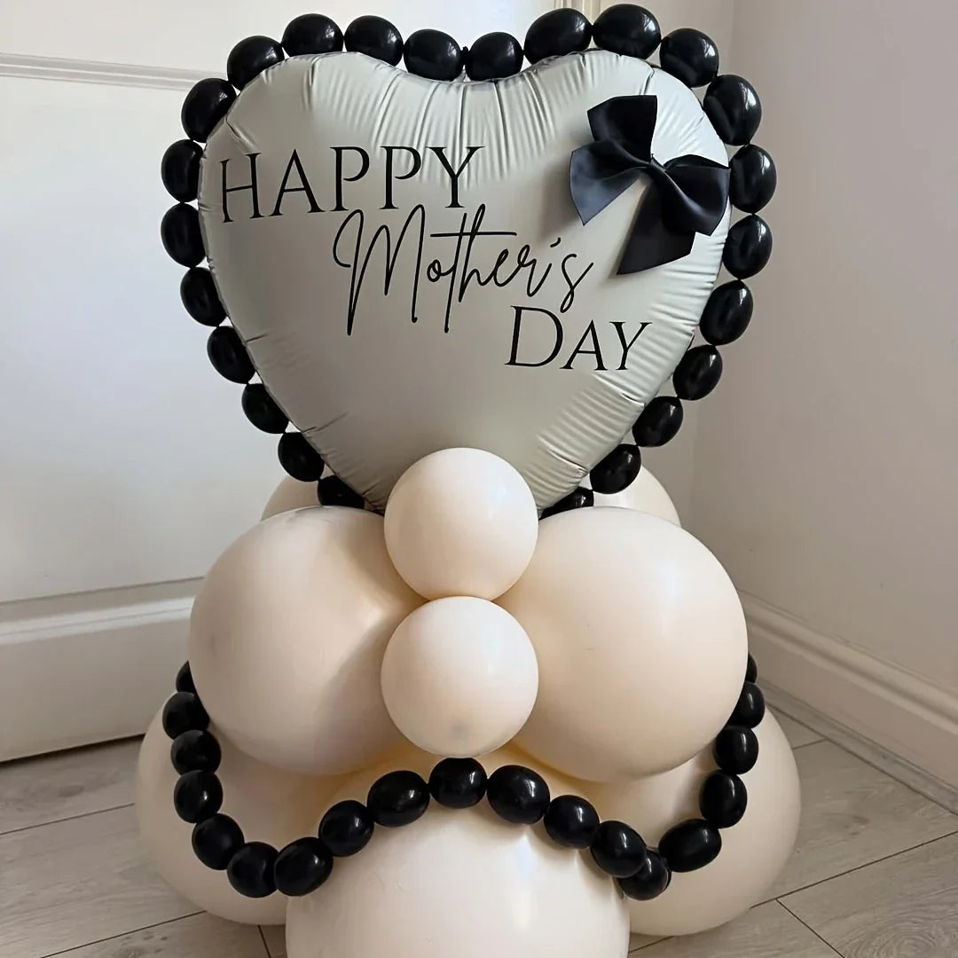 Heart-shaped silver balloon with Happy Mother's Day text, decorated with black and white balloon stack