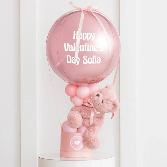 Pink hot air balloon decoration with a teddy bear and Valentine’s Day message in Dubai