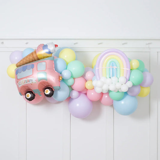 Pastel balloon garland with ice cream truck and rainbow foil balloons for party decoration