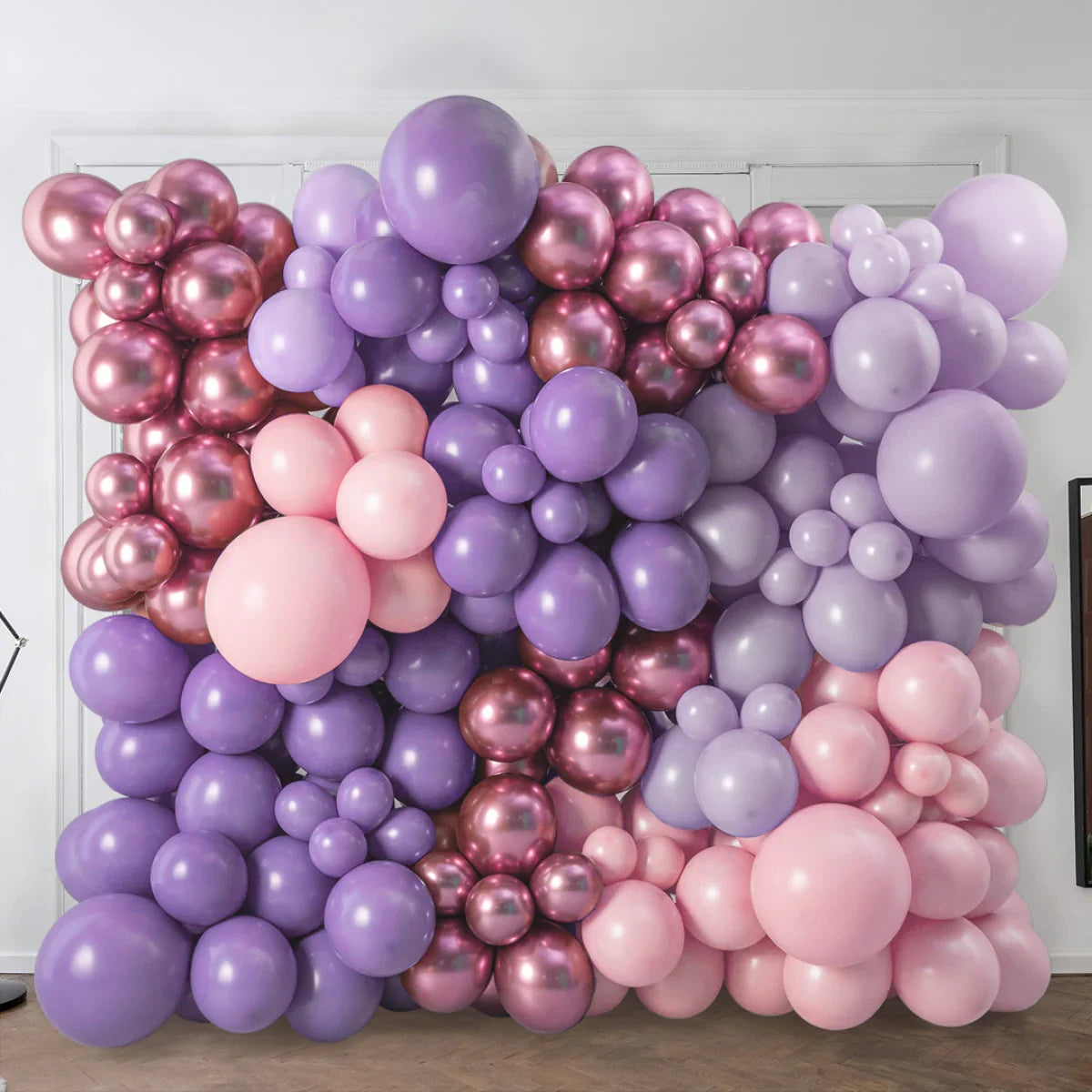 Lavender and rose gold balloon wall backdrop with pink accents for event decoration in modern room